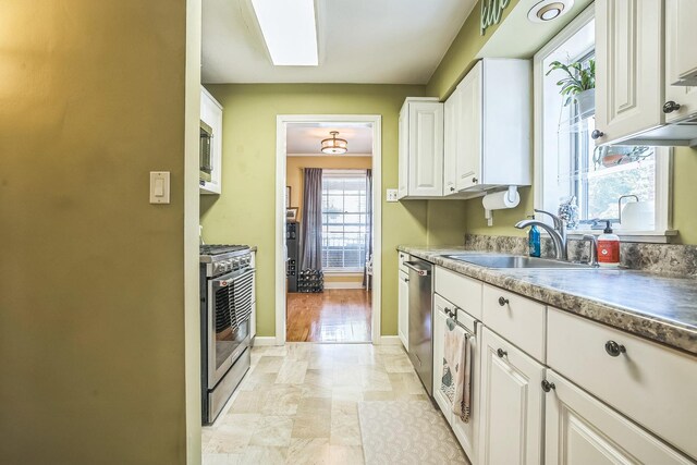7805 W Farragut Ave, Chicago, IL 60656 - kitchen featuring appliances with stainless steel finishes and white cabinetry