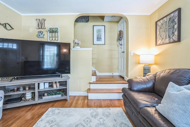 7805 W Farragut Ave, Chicago, IL 60656 - living room featuring arched walkways, ornamental molding, wood finished floors, and stairway