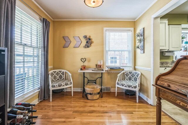 7805 W Farragut Ave, Chicago, IL 60656 - sitting room featuring light wood-style floors, healthy amount of natural light, and ornamental molding