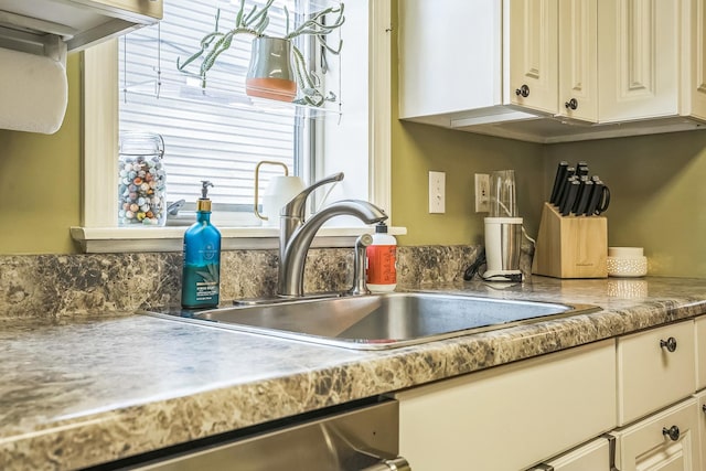 7805 W Farragut Ave, Chicago, IL 60656 - kitchen view of white cabinets, stainless steel dishwasher, and light countertops