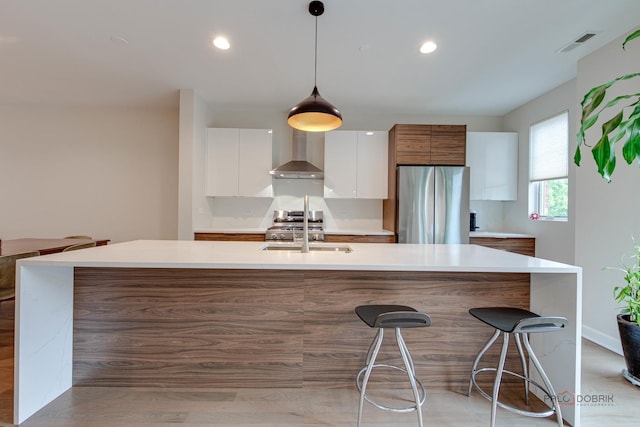 42 Legacy Ln, Wheeling, IL 60090 - kitchen with appliances with stainless steel finishes, wall chimney exhaust hood, modern cabinets, white cabinetry, and light countertops