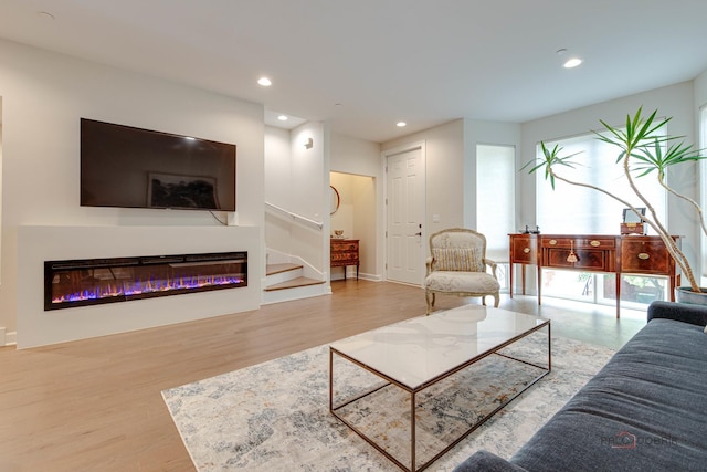 42 Legacy Ln, Wheeling, IL 60090 - living room featuring wood finished floors, recessed lighting, a glass covered fireplace, and stairway