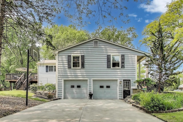 115 Circle Dr W, Montgomery, IL 60538 - view of property exterior with a garage, concrete driveway, a deck, and stairway
