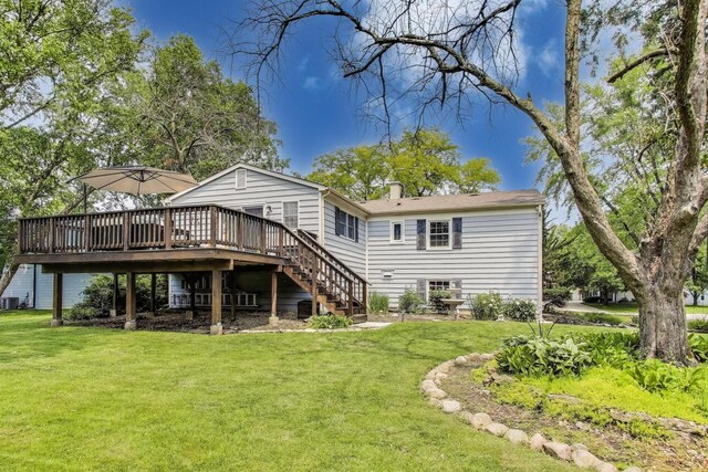 115 Circle Dr W, Montgomery, IL 60538 - rear view of house featuring a deck, a yard, stairway, and a chimney