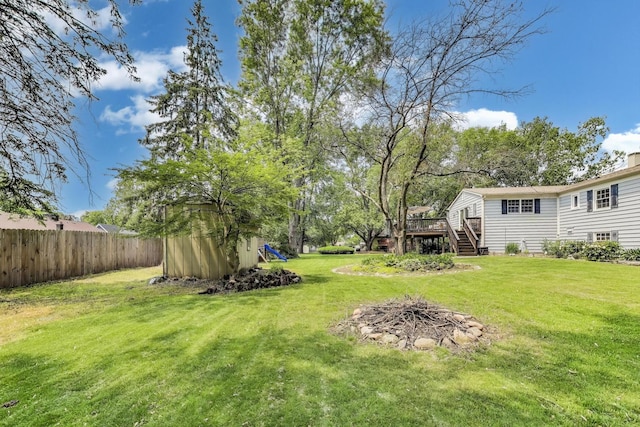 115 Circle Dr W, Montgomery, IL 60538 - view of yard with a deck, stairway, a storage shed, and a fire pit