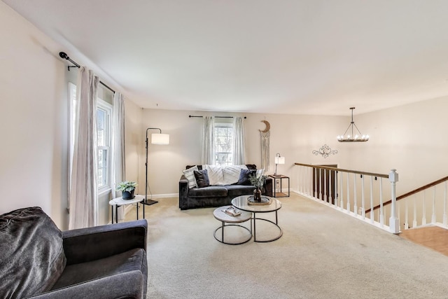115 Circle Dr W, Montgomery, IL 60538 - carpeted living area with a chandelier and baseboards
