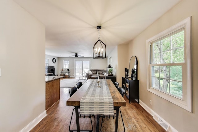115 Circle Dr W, Montgomery, IL 60538 - dining area with wood finished floors, a chandelier, and ceiling fan