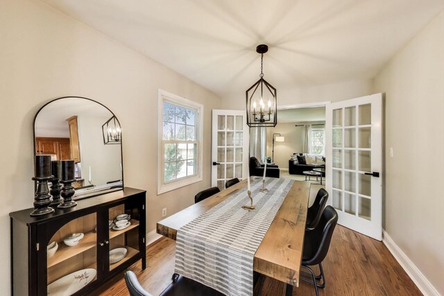 115 Circle Dr W, Montgomery, IL 60538 - dining room featuring dark wood-style floors, a chandelier, and french doors