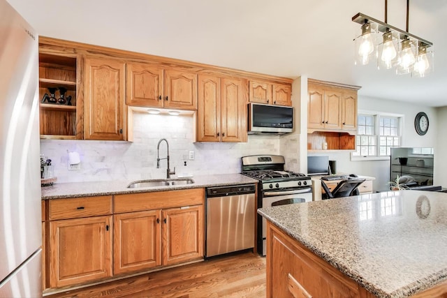 115 Circle Dr W, Montgomery, IL 60538 - kitchen featuring stainless steel appliances, open shelves, light stone countertops, light wood finished floors, and tasteful backsplash