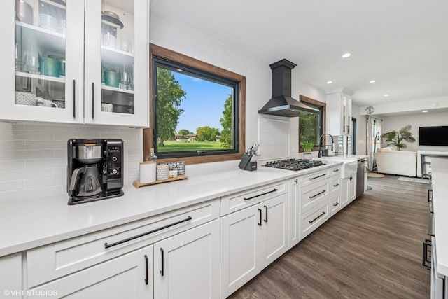 1227 Timber Dr, Elk Grove Village, IL 60007 - kitchen with wall chimney range hood, white cabinetry, gas stovetop, decorative backsplash, and light countertops