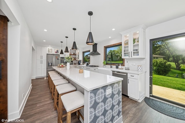 1227 Timber Dr, Elk Grove Village, IL 60007 - kitchen featuring appliances with stainless steel finishes, wall chimney range hood, dark wood finished floors, healthy amount of natural light, and recessed lighting