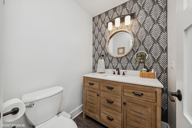 1227 Timber Dr, Elk Grove Village, IL 60007 - half bath featuring vanity, an accent wall, wallpapered walls, and wood finished floors
