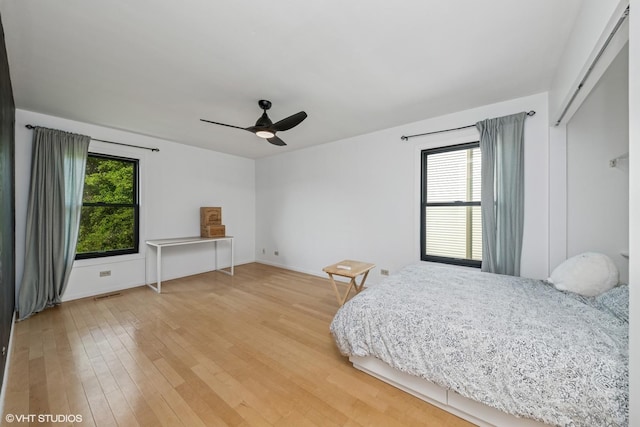 1227 Timber Dr, Elk Grove Village, IL 60007 - bedroom with multiple windows, light wood-type flooring, and a ceiling fan