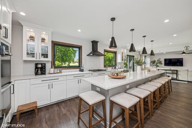 1227 Timber Dr, Elk Grove Village, IL 60007 - kitchen with wall chimney exhaust hood, light countertops, dark wood-type flooring, gas cooktop, and recessed lighting