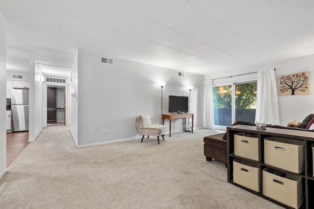 491 Timber Ridge Dr Unit 104, Carol Stream, IL 60188 - carpeted living area featuring baseboards
