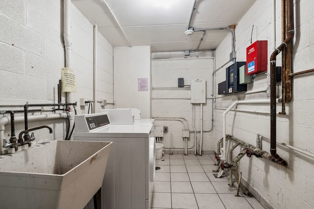 491 Timber Ridge Dr Unit 104, Carol Stream, IL 60188 - community laundry room featuring concrete block wall, separate washer and dryer, and light tile patterned floors