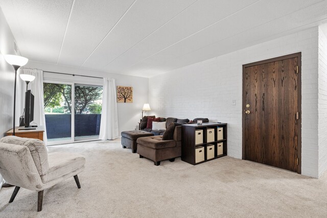 491 Timber Ridge Dr Unit 104, Carol Stream, IL 60188 - carpeted living room with brick wall