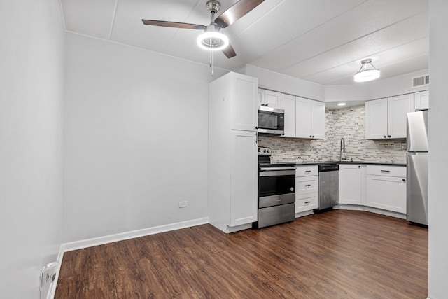 491 Timber Ridge Dr Unit 104, Carol Stream, IL 60188 - kitchen with appliances with stainless steel finishes, dark countertops, ceiling fan, decorative backsplash, and dark wood-style floors