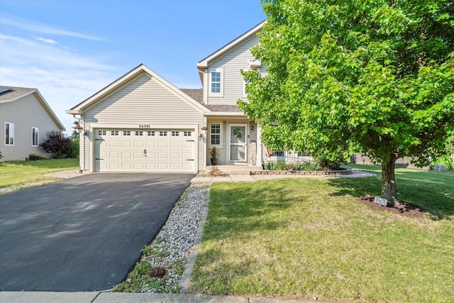 2680 Jenna Cir, Montgomery, IL 60538 - view of front facade featuring driveway, a garage, and a front lawn