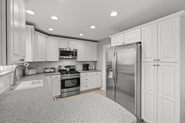 2680 Jenna Cir, Montgomery, IL 60538 - kitchen with stainless steel appliances, white cabinetry, recessed lighting, and decorative backsplash