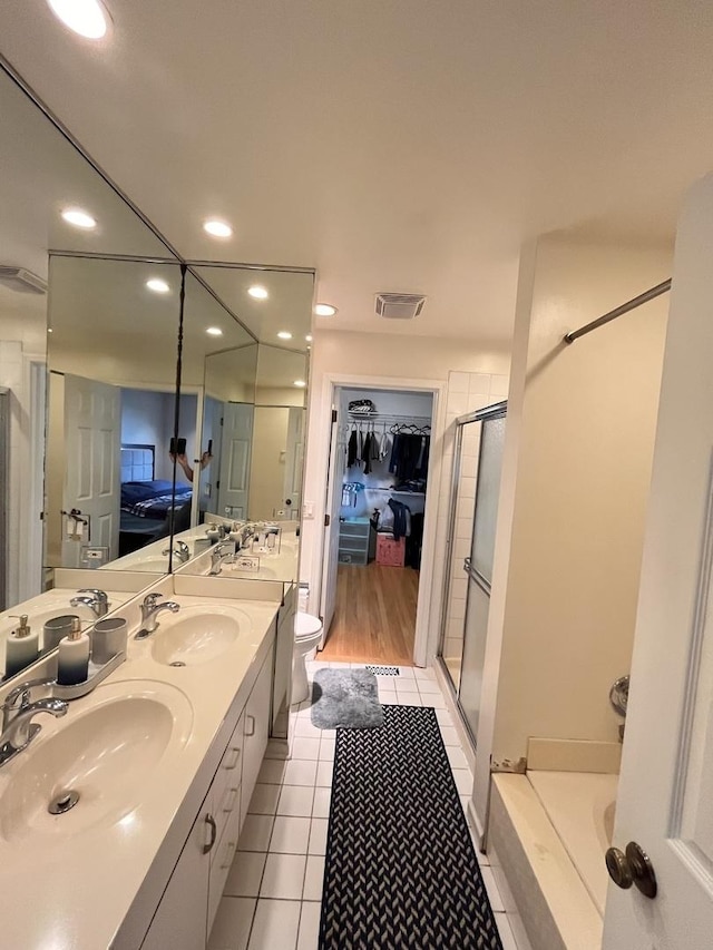 10 Chestnut Ct E, Buffalo Grove, IL 60089 - full bathroom with recessed lighting, a stall shower, tile patterned flooring, double vanity, and a garden tub