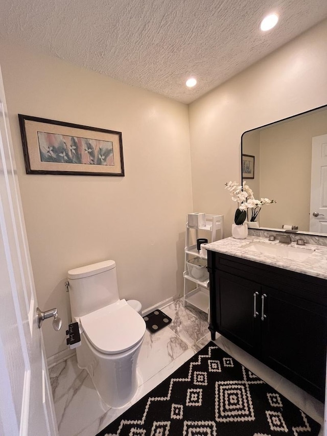 10 Chestnut Ct E, Buffalo Grove, IL 60089 - bathroom with marble look tiles, vanity, a textured ceiling, and recessed lighting