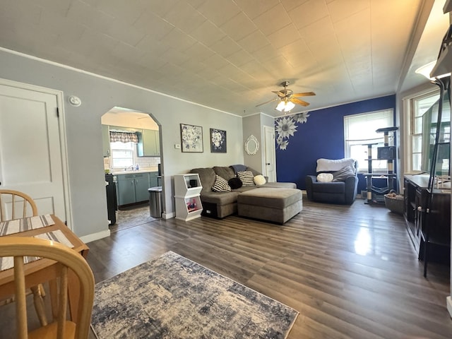 901 N Knox St, Princeton, IL 61356 - living area with arched walkways, ceiling fan, and dark wood finished floors