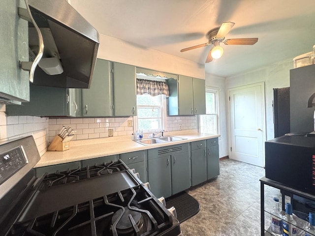 901 N Knox St, Princeton, IL 61356 - kitchen featuring light countertops, black gas stove, ceiling fan, decorative backsplash, and range hood