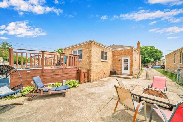 11334 S Central Park Ave, Chicago, IL 60655 - rear view of property featuring a patio area, a wooden deck, a chimney, brick siding, and a gate