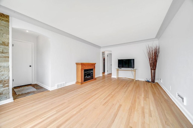 11334 S Central Park Ave, Chicago, IL 60655 - unfurnished living room with arched walkways, light wood-style flooring, and a fireplace