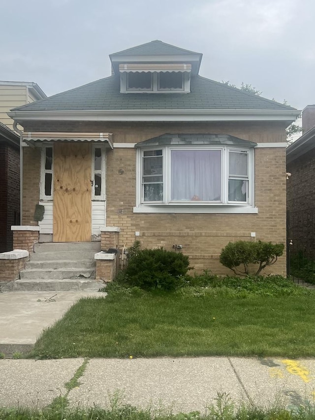 8723 S Hermitage Ave, Chicago, IL 60620 - view of front of home with entry steps, brick siding, and a front lawn