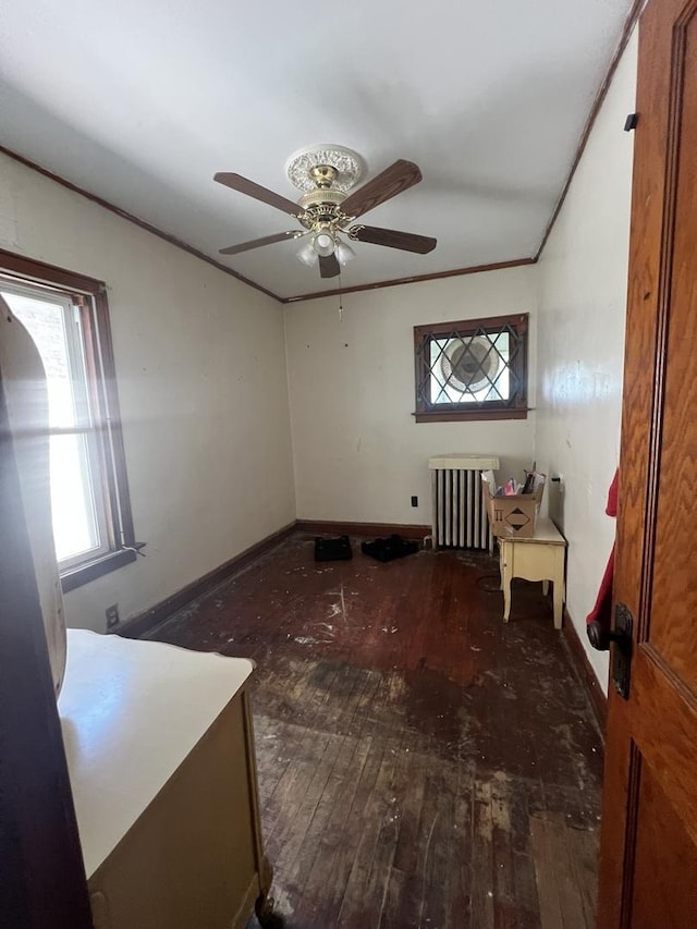 8723 S Hermitage Ave, Chicago, IL 60620 - spare room with radiator heating unit, wood-type flooring, a ceiling fan, and crown molding