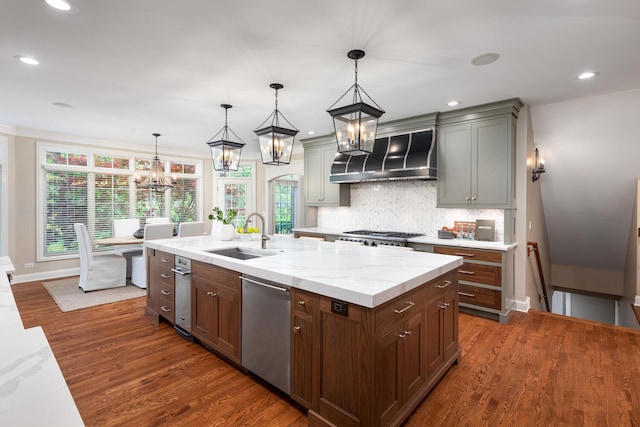 1046 Sylvan Cir, Naperville, IL 60540 - kitchen with wall chimney range hood, appliances with stainless steel finishes, a chandelier, dark wood finished floors, and decorative backsplash