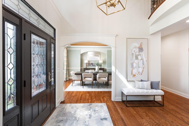 1046 Sylvan Cir, Naperville, IL 60540 - entrance foyer featuring arched walkways, wood finished floors, a chandelier, and a towering ceiling
