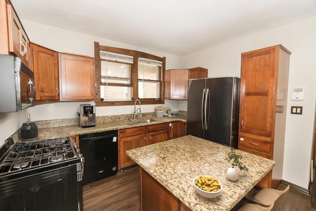 3110 N 78th Ave, Elmwood Park, IL 60707 - kitchen featuring appliances with stainless steel finishes, dark wood-type flooring, light stone counters, brown cabinets, and a center island