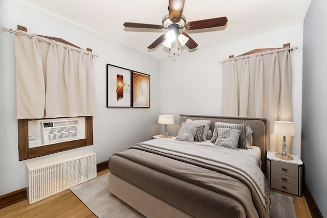 3110 N 78th Ave, Elmwood Park, IL 60707 - bedroom featuring radiator heating unit, wood finished floors, and a ceiling fan