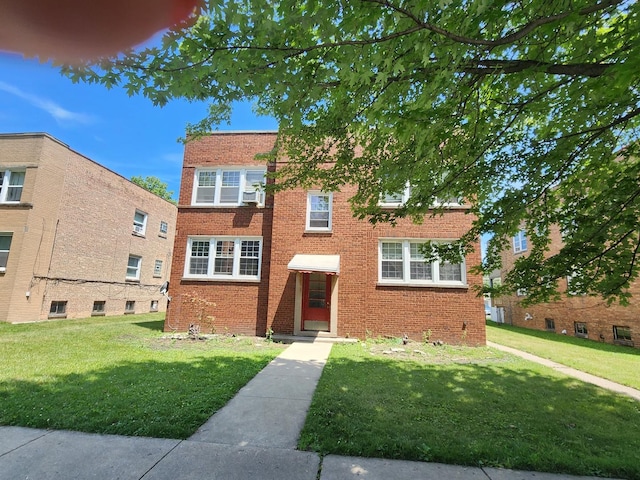 6539 N California Ave Unit 2S, Chicago, IL 60645 - view of front of house featuring a front lawn and brick siding