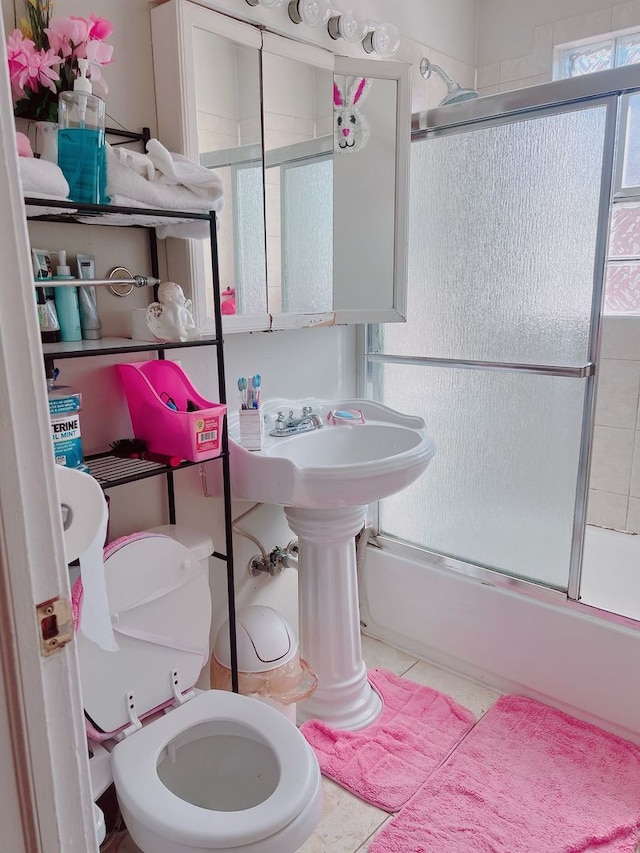 6539 N California Ave Unit 2S, Chicago, IL 60645 - bathroom featuring combined bath / shower with glass door and tile patterned floors