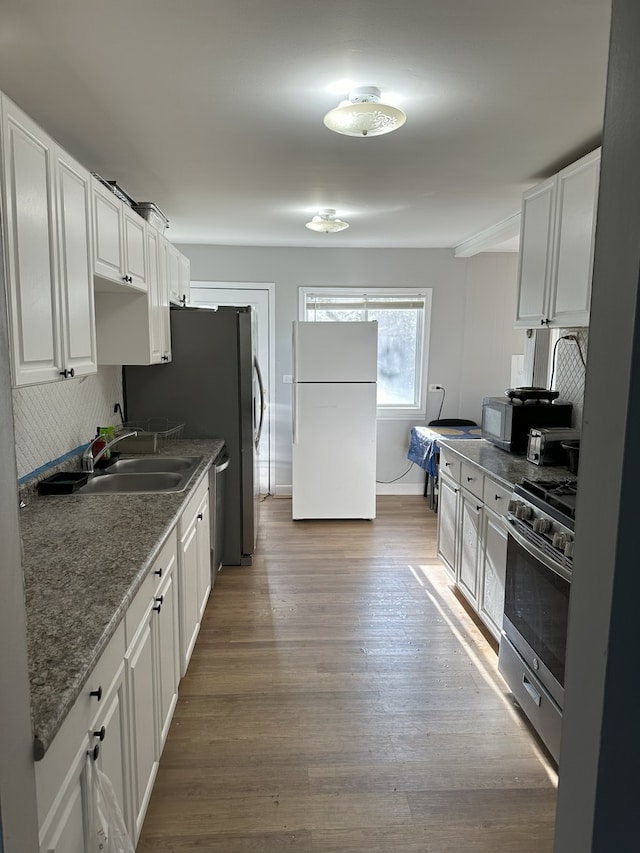 700 Cumberland St, Hoffman Estates, IL 60194 - kitchen with freestanding refrigerator, stainless steel gas range, tasteful backsplash, and light wood-style floors