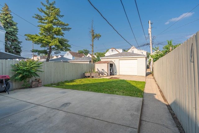 2103 N Long Ave, Chicago, IL 60639 - fenced backyard featuring a patio, concrete driveway, a detached garage, and a storage shed