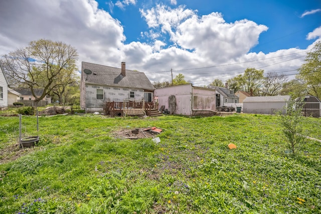 230 W Garfiled Ave, Decatur, IL 62526 - rear view of house featuring a deck, a lawn, and a chimney