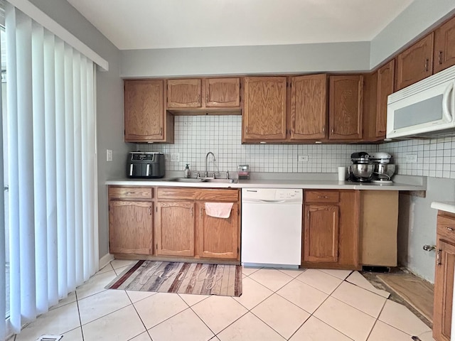 1277 Donegal Ct, Carol Stream, IL 60188 - kitchen with white appliances, light countertops, backsplash, and light tile patterned floors