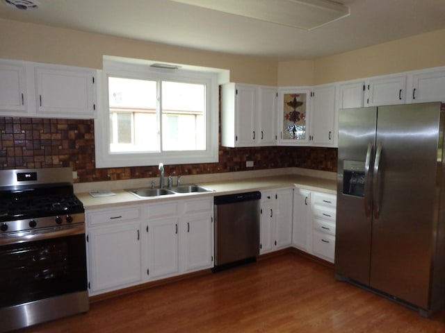 5157 W 90th St, Oak Lawn, IL 60453 - kitchen with stainless steel appliances, white cabinets, backsplash, and light countertops
