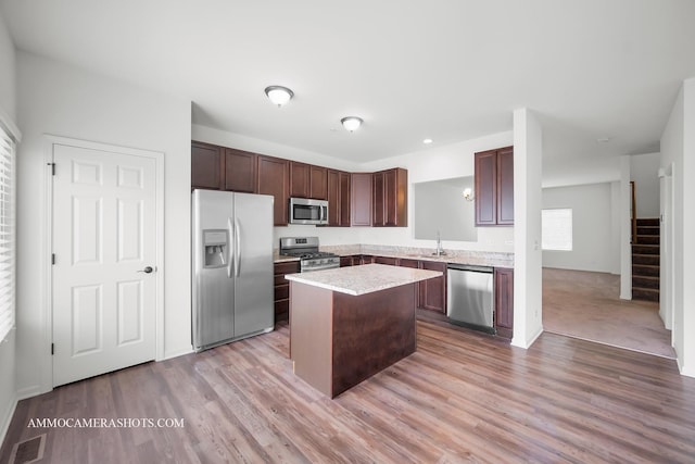 1405 Manning Ave, Montgomery, IL 60538 - kitchen featuring stainless steel appliances, a center island, light countertops, light wood-type flooring, and dark brown cabinets