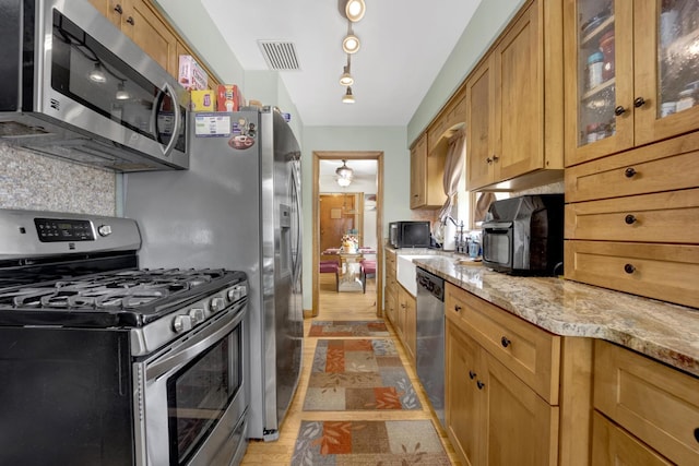 648 S Illinois Ave, Villa Park, IL 60181 - kitchen with appliances with stainless steel finishes, light stone counters, glass insert cabinets, decorative backsplash, and brown cabinets