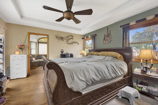 648 S Illinois Ave, Villa Park, IL 60181 - bedroom featuring a tray ceiling, wood finished floors, and a ceiling fan