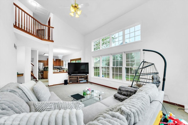 1456 Della Dr, Hoffman Estates, IL 60169 - living room with high vaulted ceiling, light carpet, baseboards, ceiling fan, and stairway
