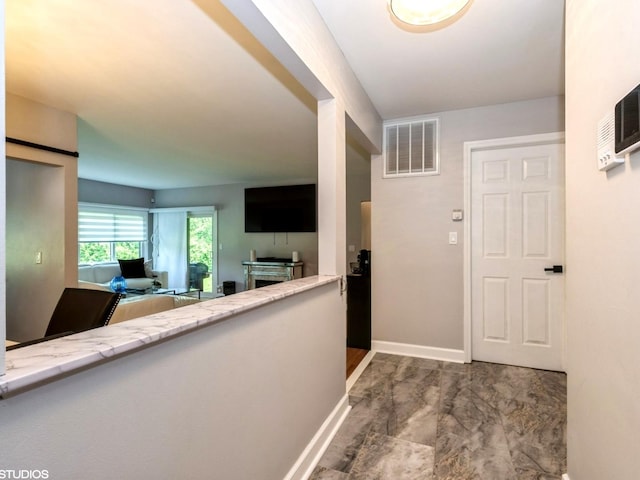 1022 Pinetree Cir N Unit 1022, Buffalo Grove, IL 60089 - hall featuring marble look tile flooring and baseboards
