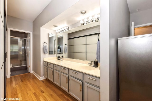 1022 Pinetree Cir N Unit 1022, Buffalo Grove, IL 60089 - full bathroom with double vanity, wood finished floors, and a shower
