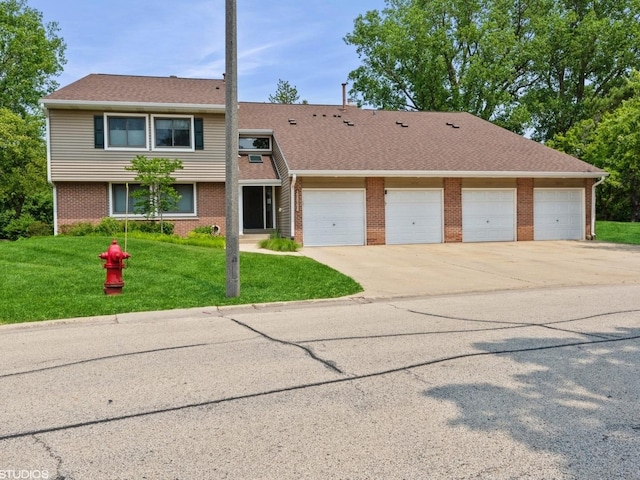 1022 Pinetree Cir N Unit 1022, Buffalo Grove, IL 60089 - view of property with brick siding, driveway, a front yard, an attached garage, and roof with shingles